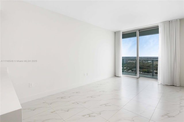 spare room featuring floor to ceiling windows