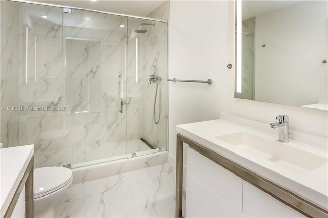 bathroom featuring vanity, an enclosed shower, and toilet