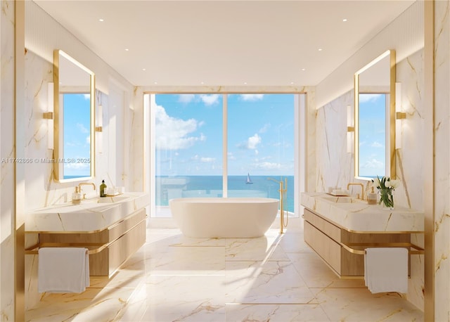 bathroom featuring a water view, vanity, a tub to relax in, and expansive windows