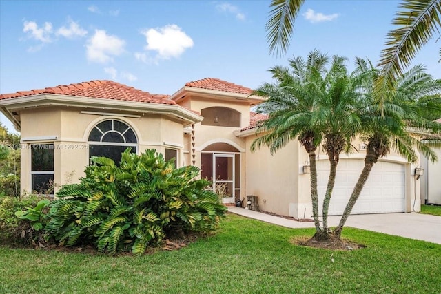 mediterranean / spanish-style home featuring a garage and a front yard