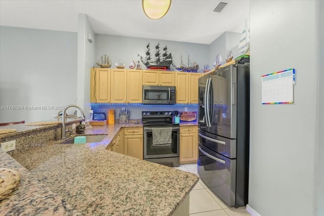 2813 Augusta Ln, Homestead, FL 33035 - kitchen featuring stainless steel appliances, light brown cabinetry, a peninsula, and light stone countertops