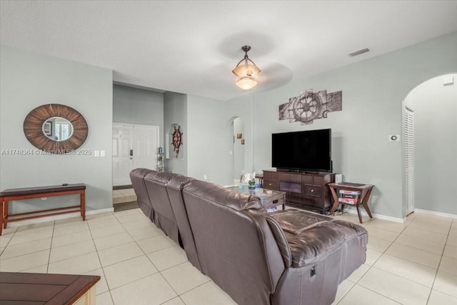 2813 Augusta Ln, Homestead, FL 33035 - living room featuring arched walkways, light tile patterned floors, and ceiling fan
