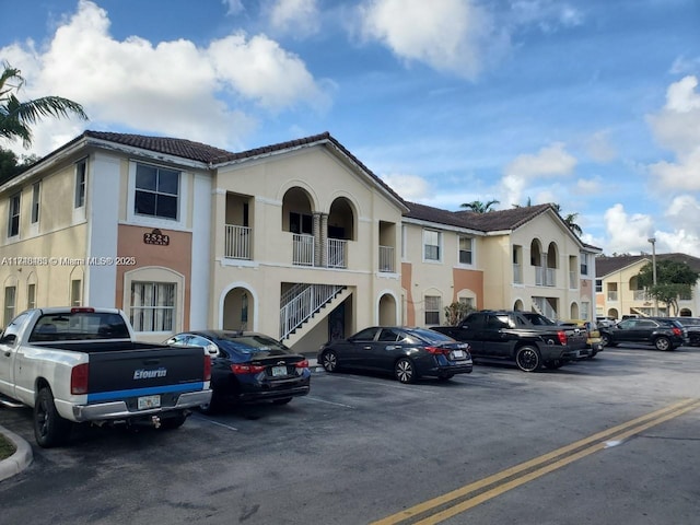 view of property featuring uncovered parking