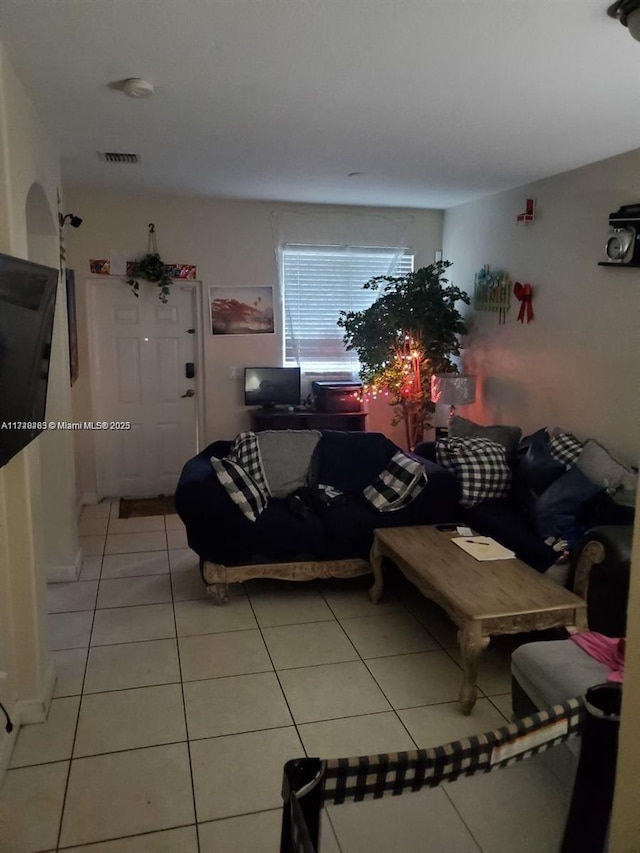 unfurnished living room with light tile patterned floors