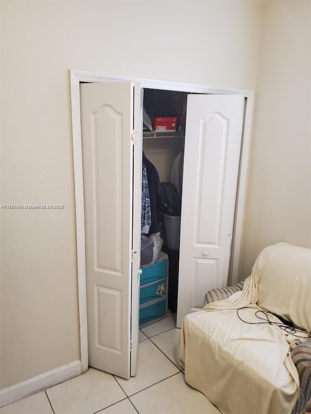 bedroom featuring a closet and light tile patterned floors