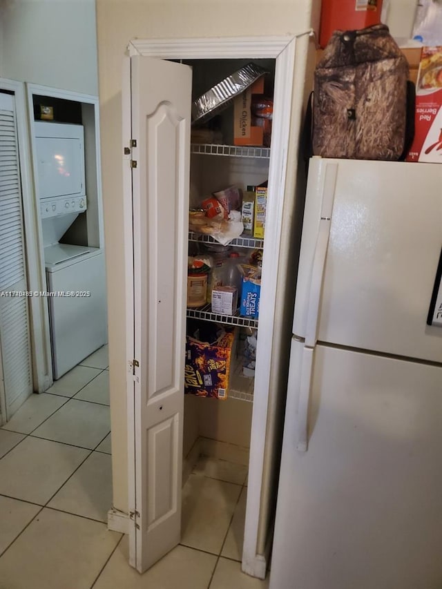 pantry with stacked washer and dryer