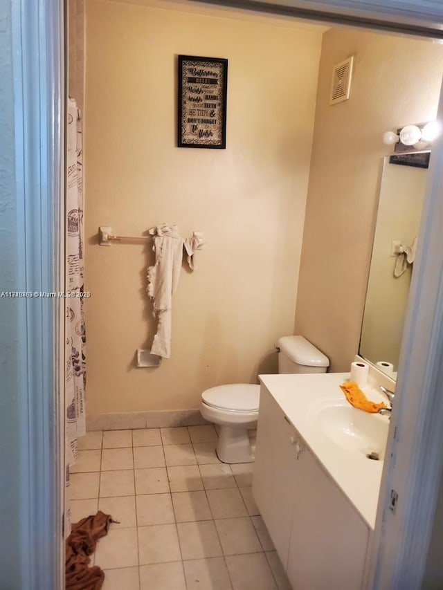 bathroom with tile patterned floors, vanity, and toilet