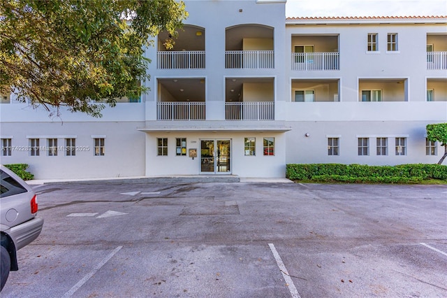 view of building exterior with uncovered parking