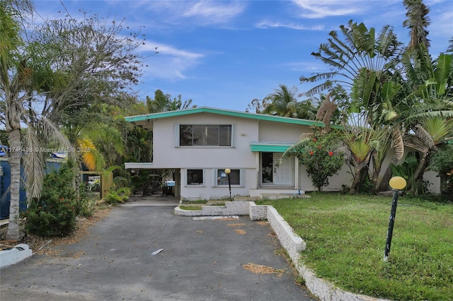 2637 Sugarloaf Ln, Fort Lauderdale, FL 33312 - view of front of property with a carport, a front lawn, stucco siding, and aphalt driveway
