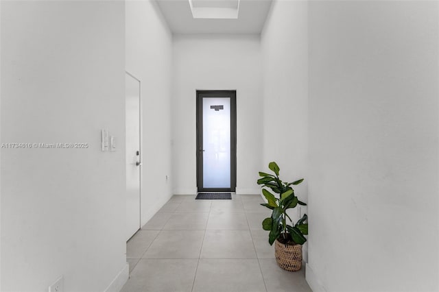 doorway with light tile patterned floors