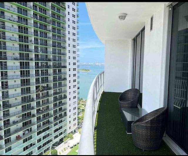 balcony featuring a water view