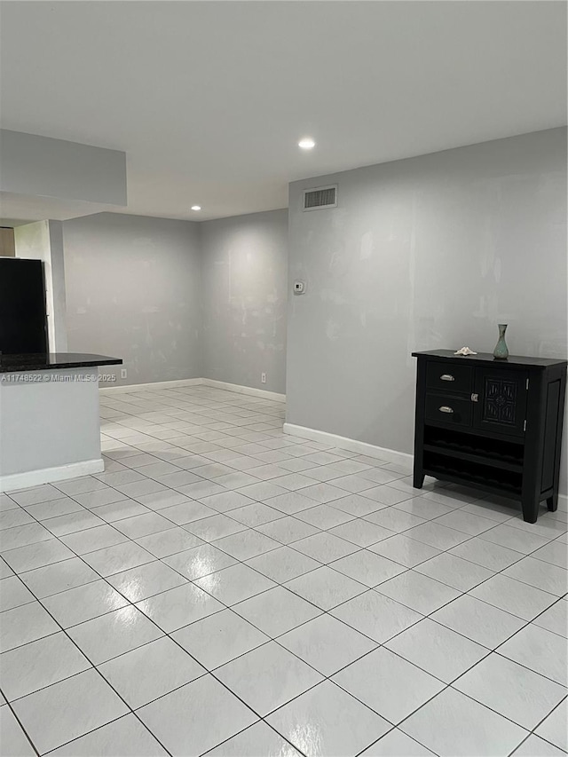 unfurnished living room with light tile patterned floors