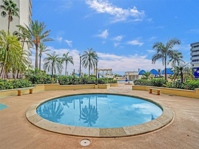outdoor pool with a patio area