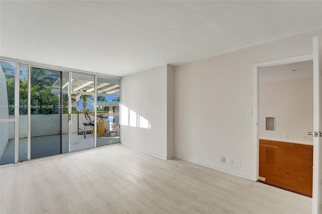 unfurnished room with light wood-style floors