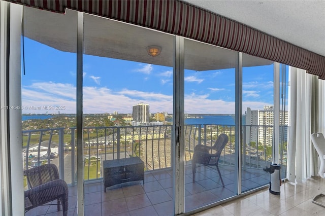 unfurnished sunroom featuring a water view