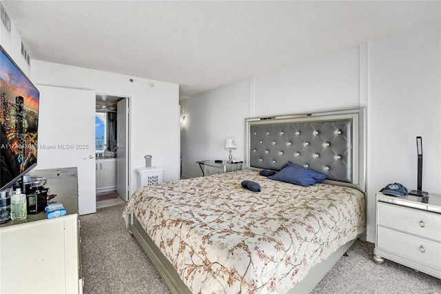 carpeted bedroom featuring a textured ceiling