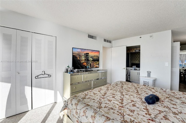 carpeted bedroom featuring a textured ceiling