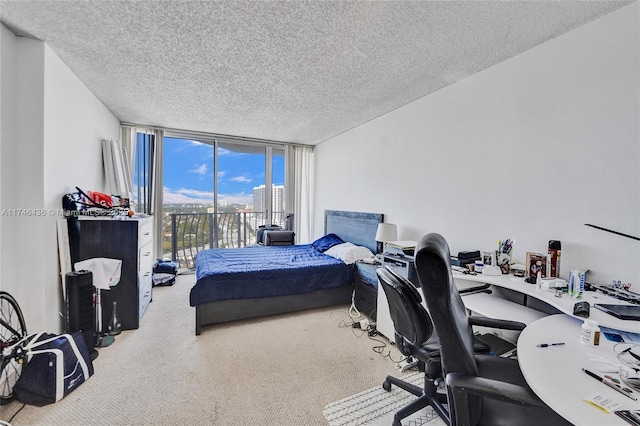 bedroom with a textured ceiling, carpet flooring, access to outside, and expansive windows