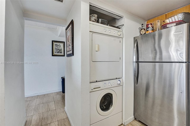 laundry room with stacked washer / drying machine