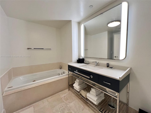 bathroom featuring vanity and a tub to relax in