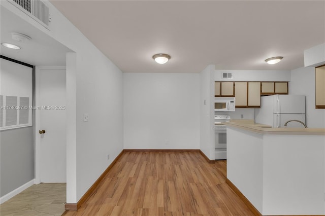 kitchen with light countertops, white appliances, visible vents, and baseboards