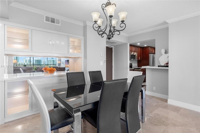 dining room with ornamental molding, a chandelier, and a textured ceiling