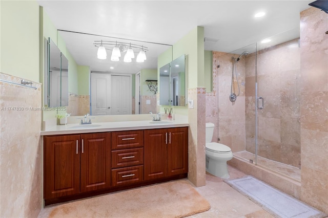 bathroom with toilet, tile walls, walk in shower, and vanity