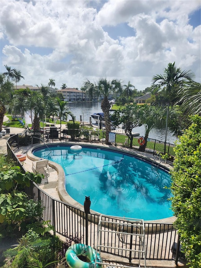 view of pool with a water view