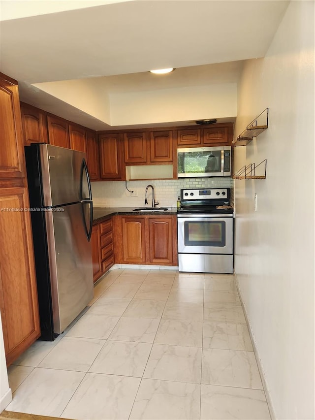 455 Golden Isles Dr Unit 309, Hallandale Beach, FL 33009 - kitchen with decorative backsplash, stainless steel appliances, and sink