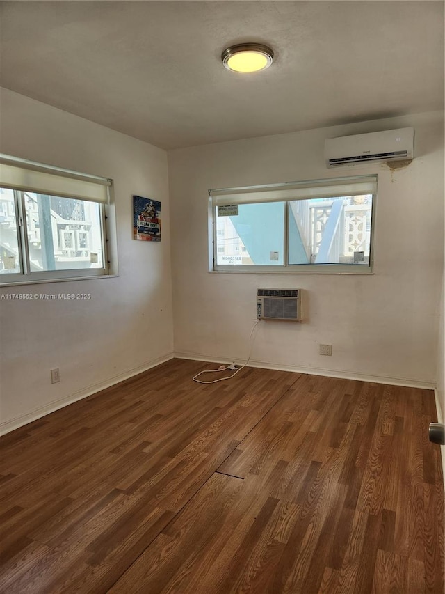 455 Golden Isles Dr Unit 309, Hallandale Beach, FL 33009 - empty room featuring dark hardwood / wood-style flooring and a wall mounted AC