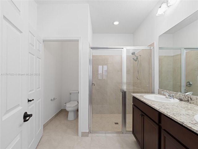 bathroom featuring a sink, toilet, a stall shower, tile patterned flooring, and double vanity