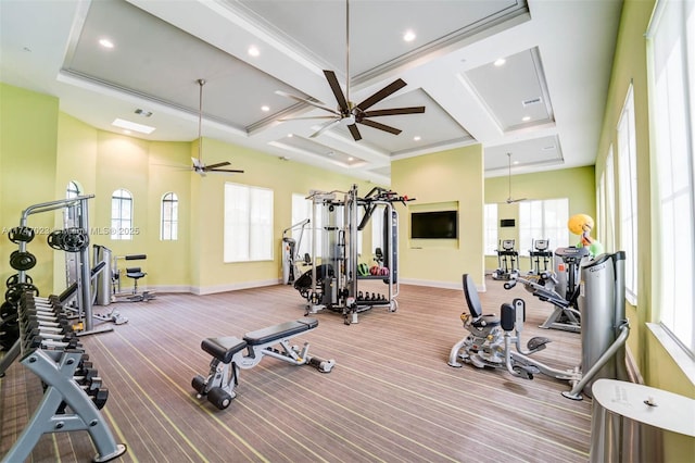 exercise room featuring baseboards, a ceiling fan, and coffered ceiling