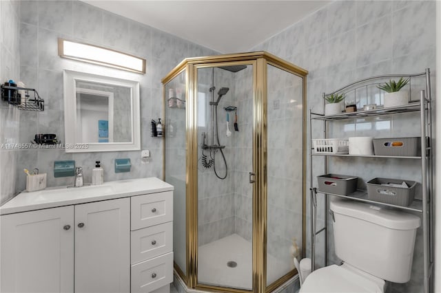full bath featuring vanity, a shower stall, tile walls, toilet, and backsplash
