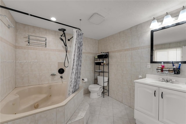 full bathroom with vanity, a combined bath / shower with jetted tub, tile walls, toilet, and tile patterned floors