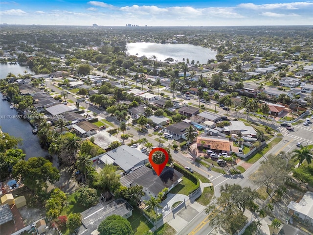 drone / aerial view featuring a residential view and a water view