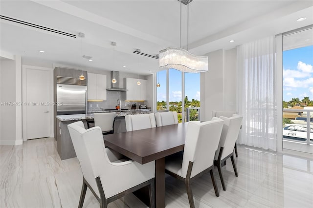 dining area with sink and expansive windows