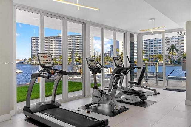 gym with a water view and expansive windows