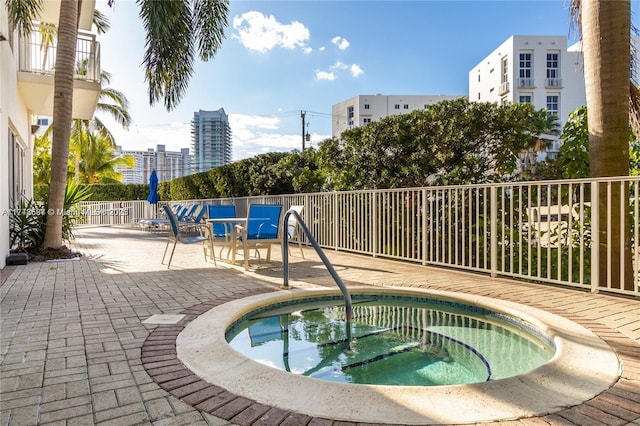 view of pool with a patio and a community hot tub