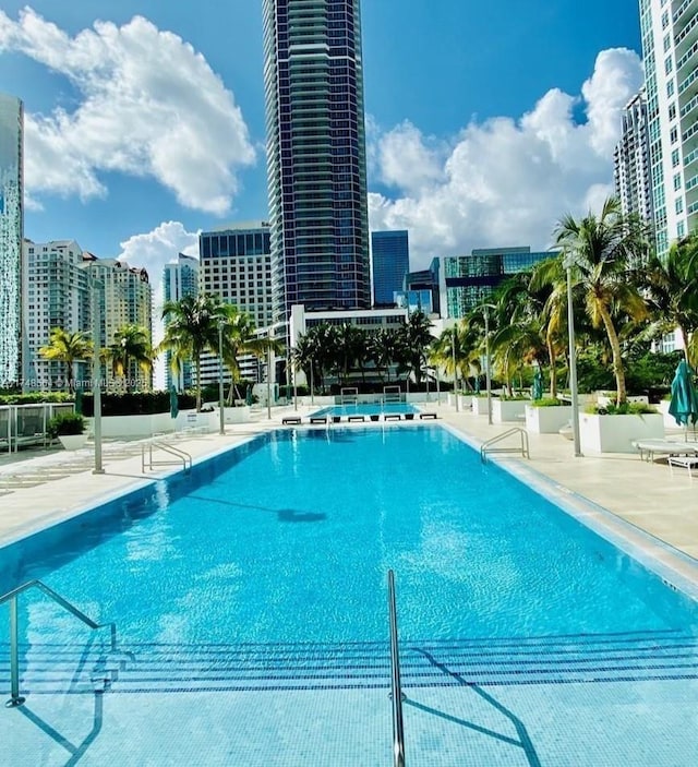 pool featuring a patio and a view of city