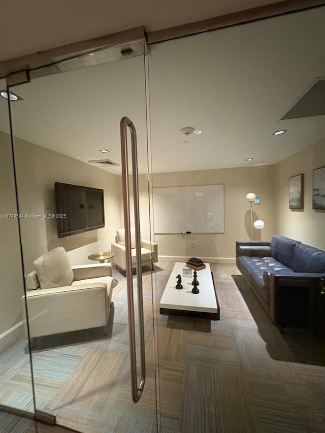 living area featuring baseboards and carpet floors