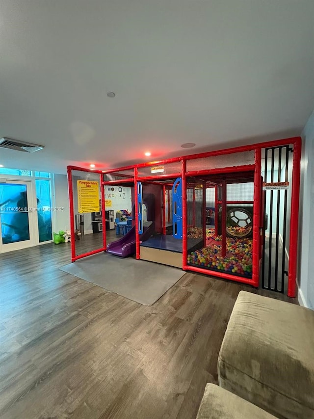 recreation room featuring wood finished floors and visible vents