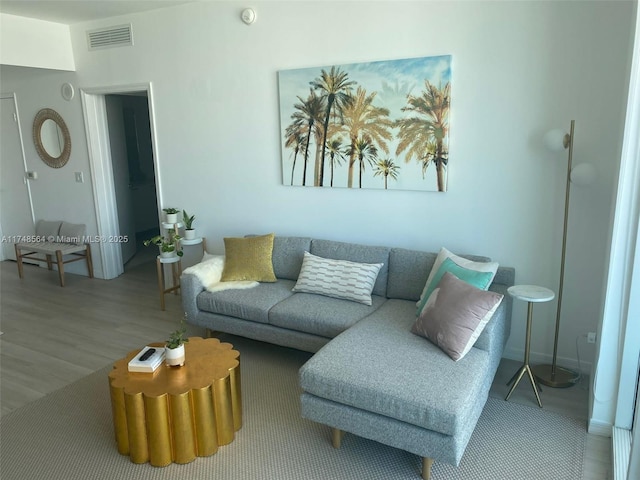 living room with visible vents and wood finished floors