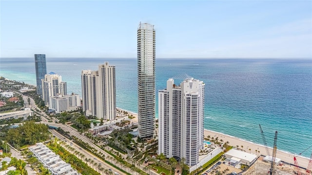 drone / aerial view featuring a water view, a view of city, and a view of the beach