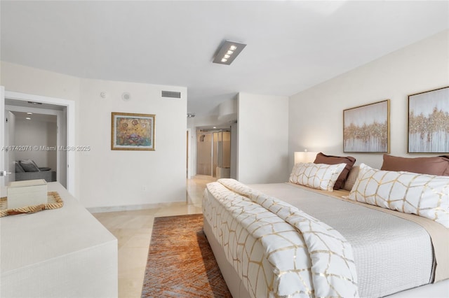 bedroom featuring visible vents and light tile patterned floors