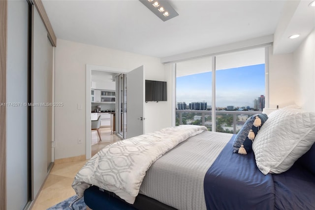 bedroom featuring expansive windows and baseboards