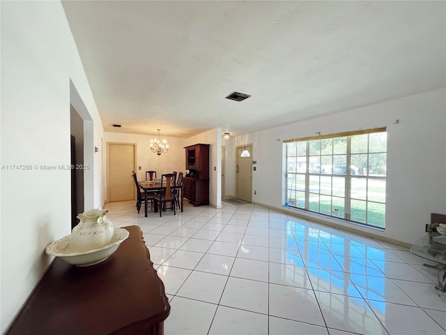 living room featuring a notable chandelier and light tile patterned floors