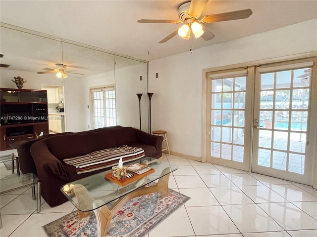 living room featuring ceiling fan, light tile patterned flooring, and french doors