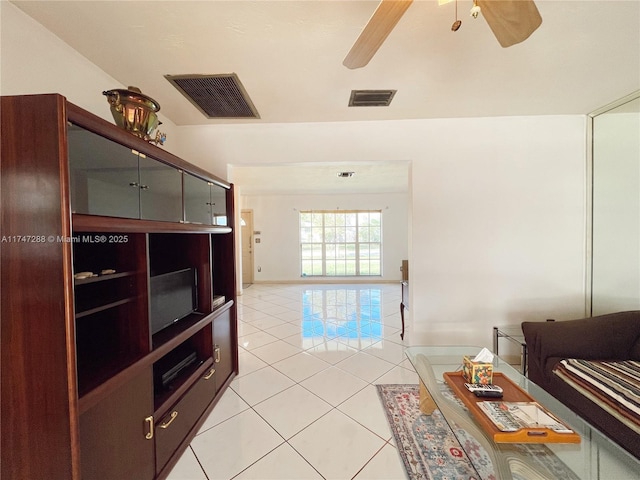 living room featuring ceiling fan and light tile patterned flooring