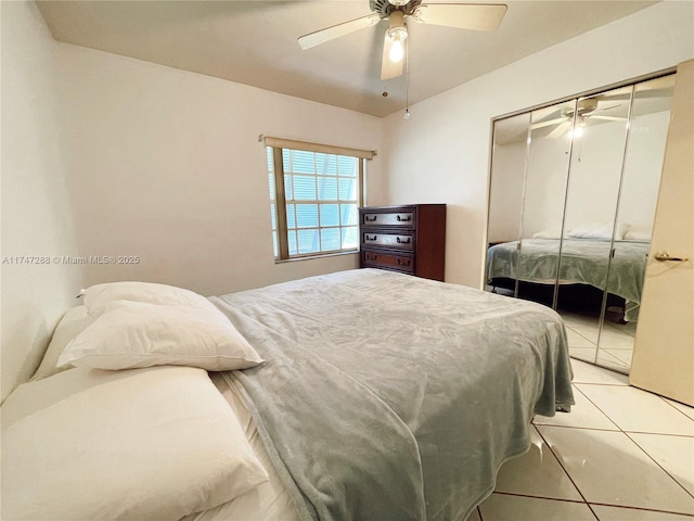 tiled bedroom with a closet and ceiling fan