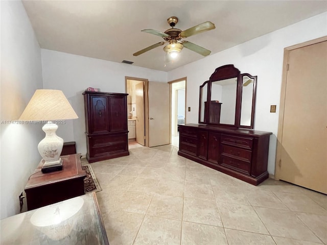 tiled bedroom with ceiling fan and ensuite bathroom